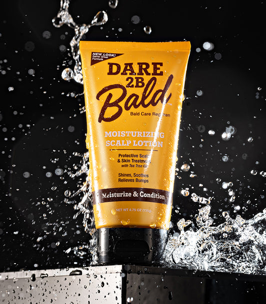Dare 2B Bald moisturizing scalp lotion tube with water splashes on a black background